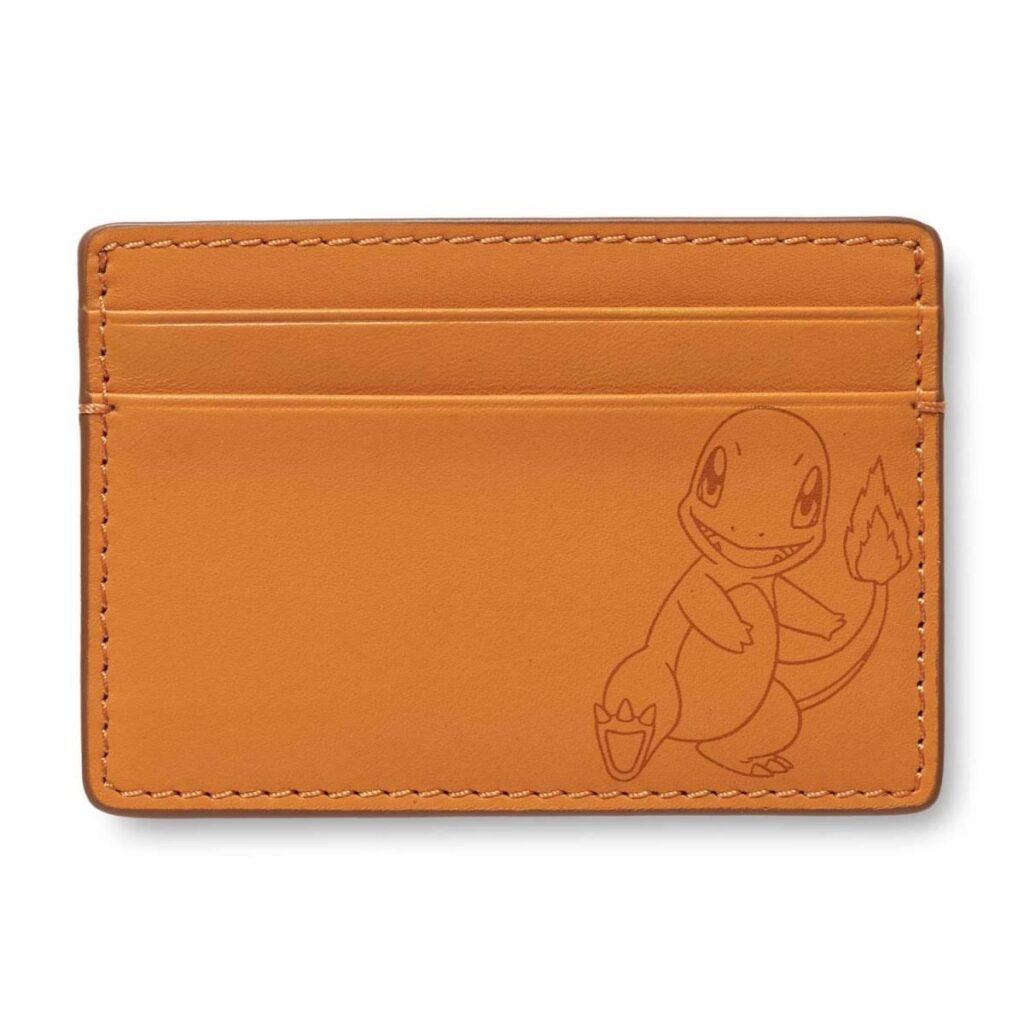 e28762a8-9279-5826-8727-3e90439fa70e-1024x1024-1.jpg Pokémon Center × Fossil: Charmander Orange Leather Steven Card Case - Image 1